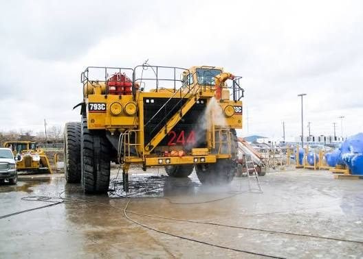 Large haul truck being pressure washed